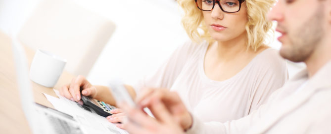 Unhappy couple with documents at home